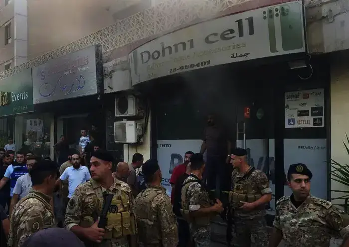 Lebanese soldiers gather outside a damaged mobile shop after what is believed to be the result of a walkie-talkie exploding inside it, in the southern port city of Sidon, Lebanon, Wednesday, Sept. 18, 2024. (AP Photo/Mohammed Zaatari)