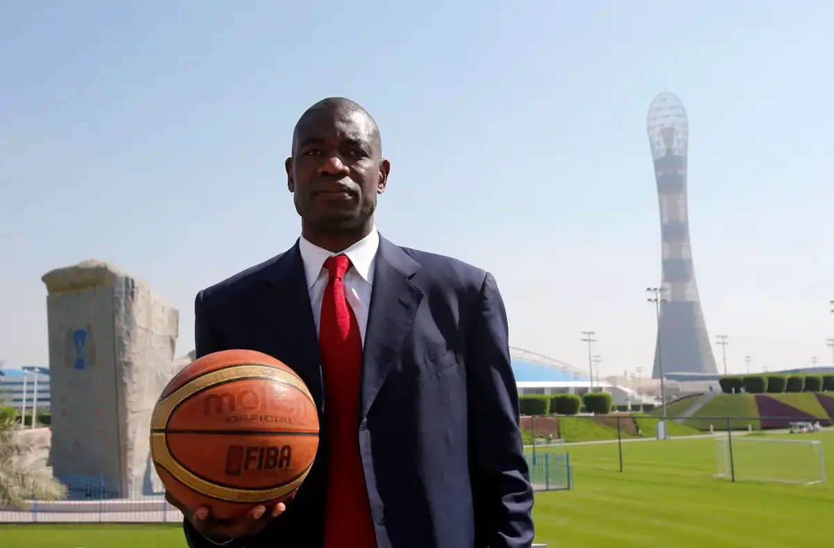 Former NBA star Dikembe Mutombo of U.S. poses before the start of a news conference at the Sports Congress and Exhibition at Aspire Dome in Doha November 12, 2012. REUTERS/Fadi Al-Assaad/File Photo