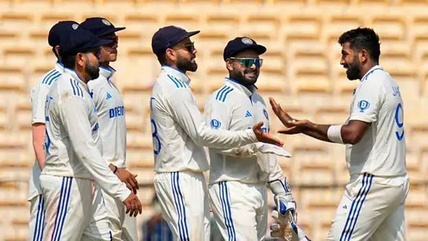 India's Jasprit Bumrah (right) celebrates with teammates after taking the wicket of Bangladesh's Hasan Mahmud on the second day of the first test (PTI)