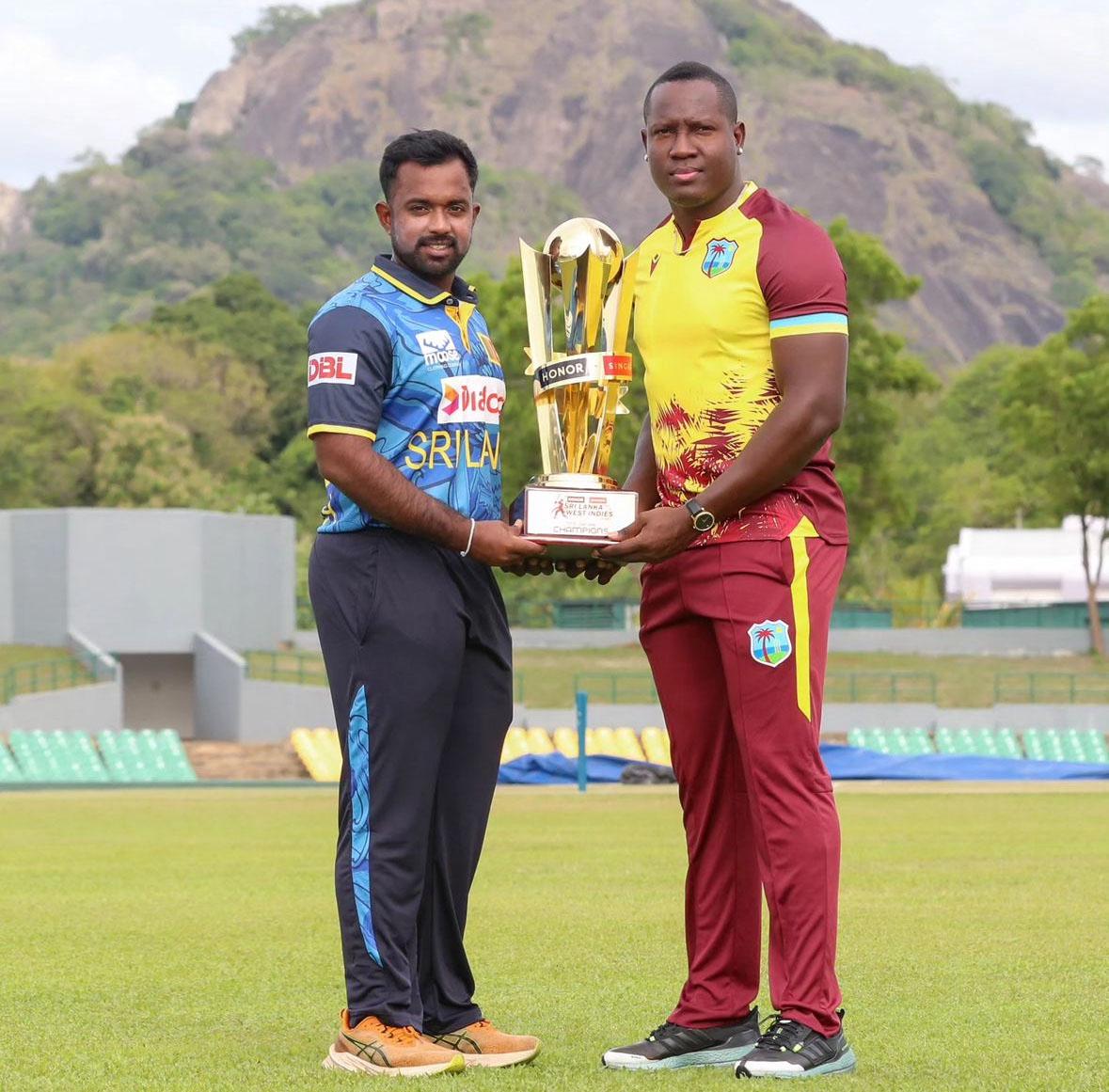 West Indies captain Rovman Powell (right) poses with the T20I series trophy alongside his Sri Lankan counterpart Charith Asalanka