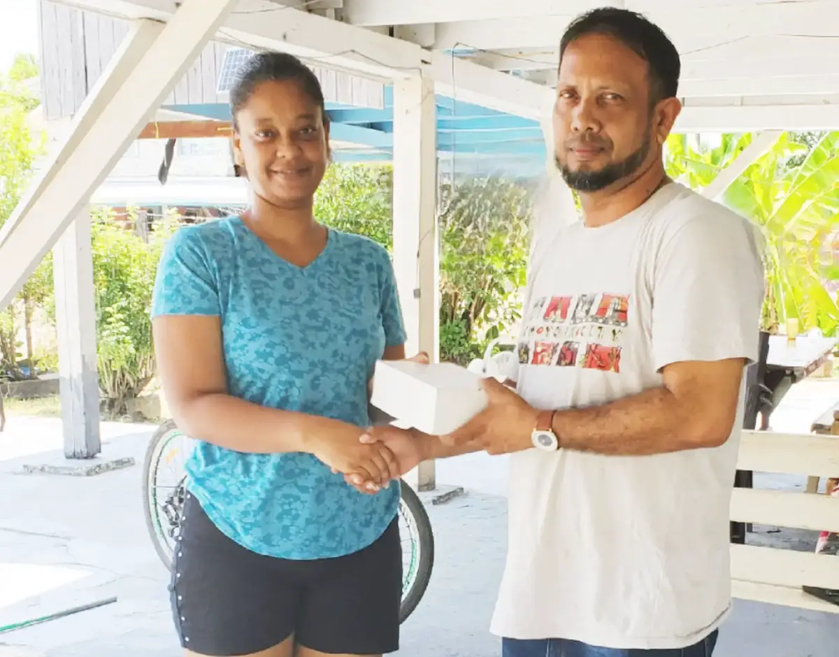 Mahendradass Nandlall (right), acting Head of Department, Allied Arts Unit of LCSS, receiving a box of cricket balls from Project Cricket Gears representative Amanda Downer Kampta