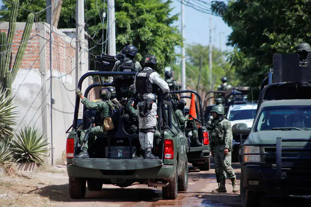 Federal forces guard the perimeter of a scene following a shootout where several suspected gang members were killed while one local cartel leader was arrested, on the outskirts of Culiacan, Sinaloa state, Mexico October 22, 2024.