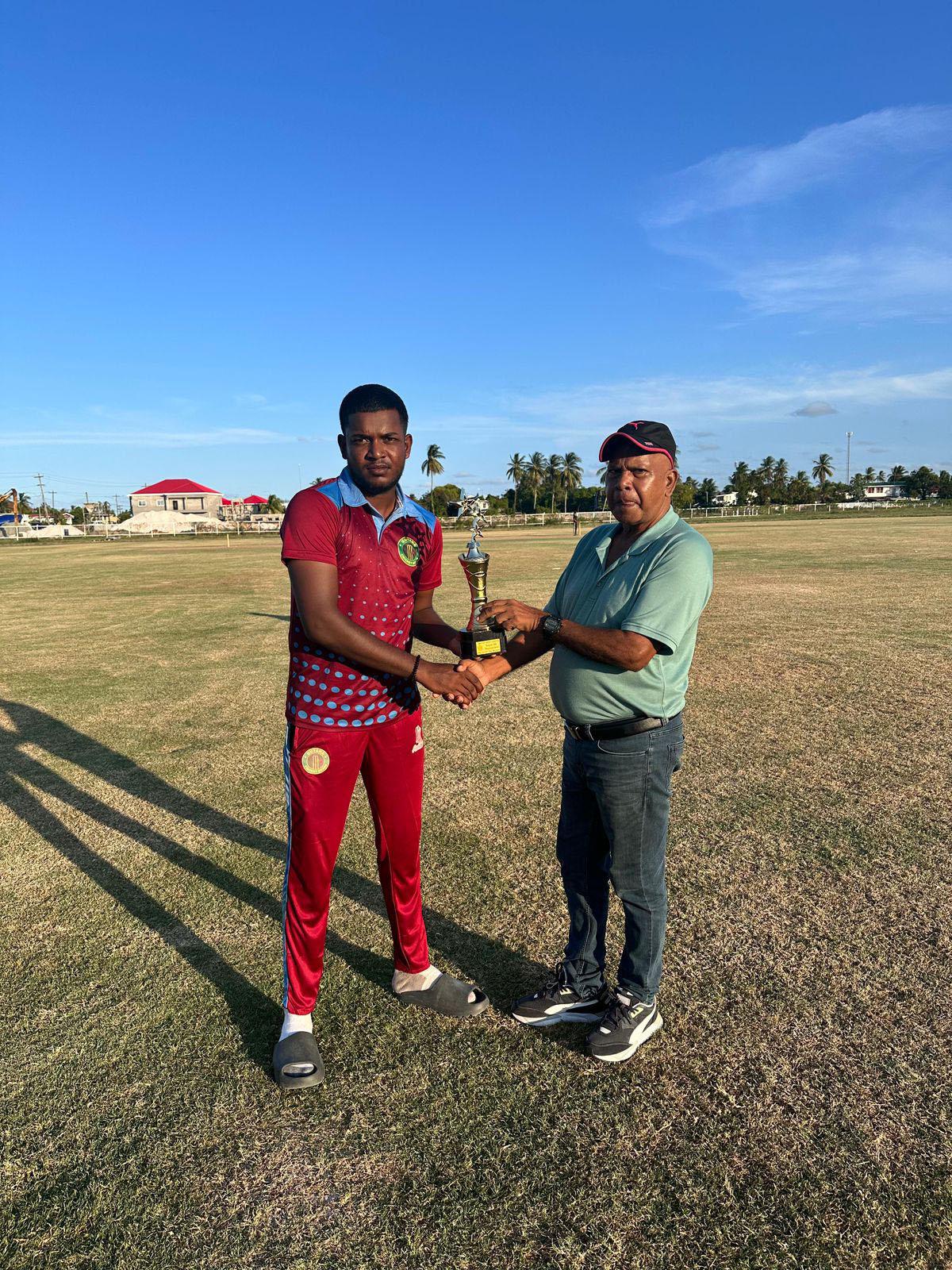 Jonathon Rampersaud collects his Man of the Match award from an official after a valuable all-round performance led his side, the GCB Select XI, to victory over Essequibo