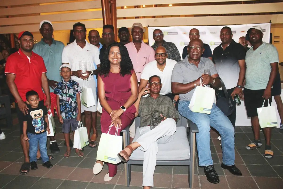 Patrick Prashad (sitting) poses with other members of team Guyana after winning the A-Class category