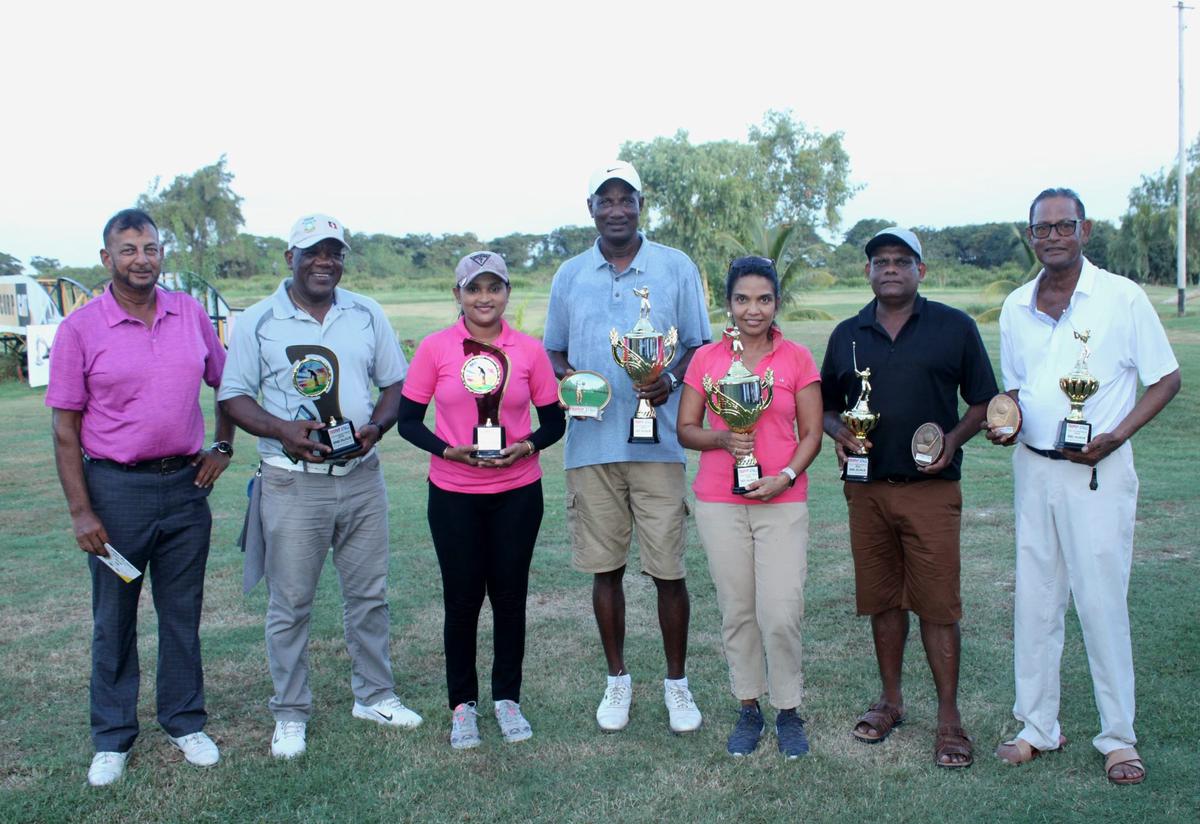 The respective winners and top three finishers pose with their spoils at the conclusion of the Trophy Stall Golf Tournament