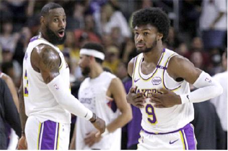 LeBron James (left) and Bronny James. AP Photo/William Liang