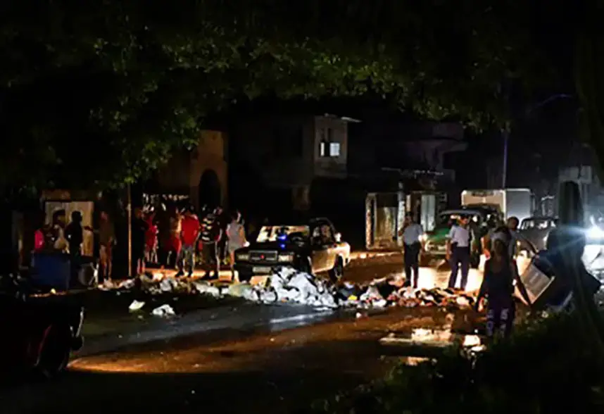 Cuban police stand next to debris used to block a street during a protest against a blackout, in Havana, Cuba October 19, 2024