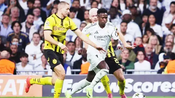 Vinicuis Jr (centre) is trying to escape the pursuits of two Borussia Dortmund defenders.