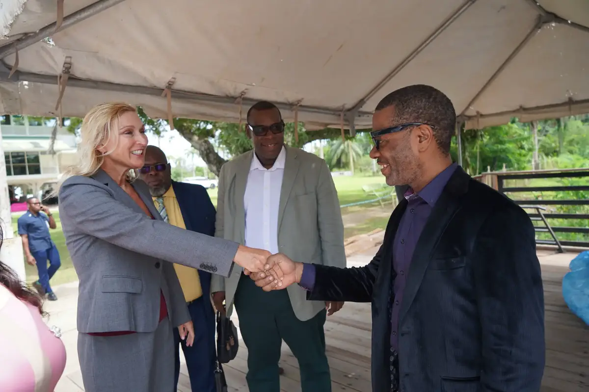 US Ambassador Nicole Theriot (left) greets Linden Mayor Sharma Solomon. (US Embassy photo)