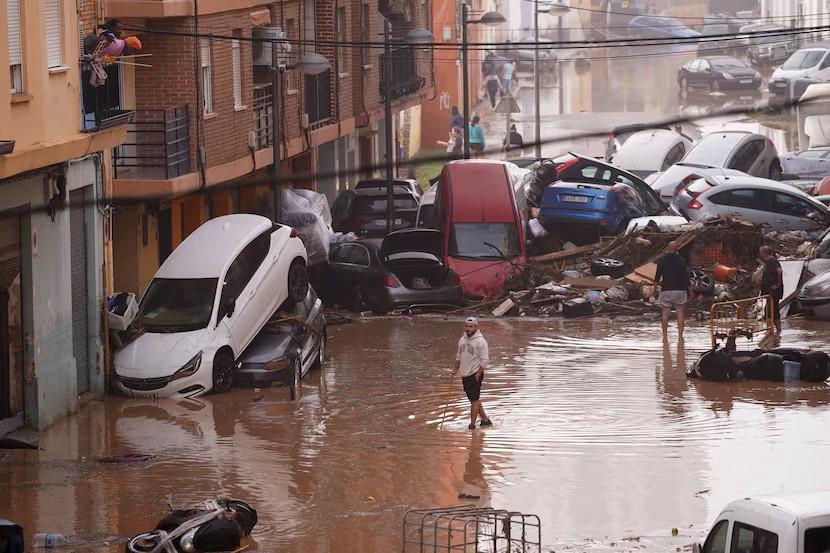 Residents look at cars piled up after being swept away by floods in Valencia, Spain, Wednesday, Oct. 30, 2024.(Alberto Saiz / AP)