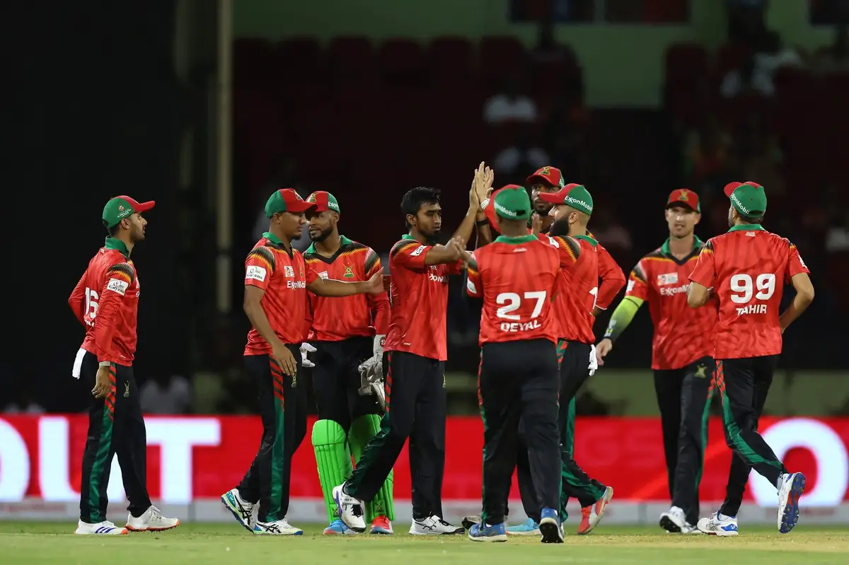 The Guyana Amazon Warriors celebrate the fall of a Lahore Qalandars wicket during the opening match of the Global Super League