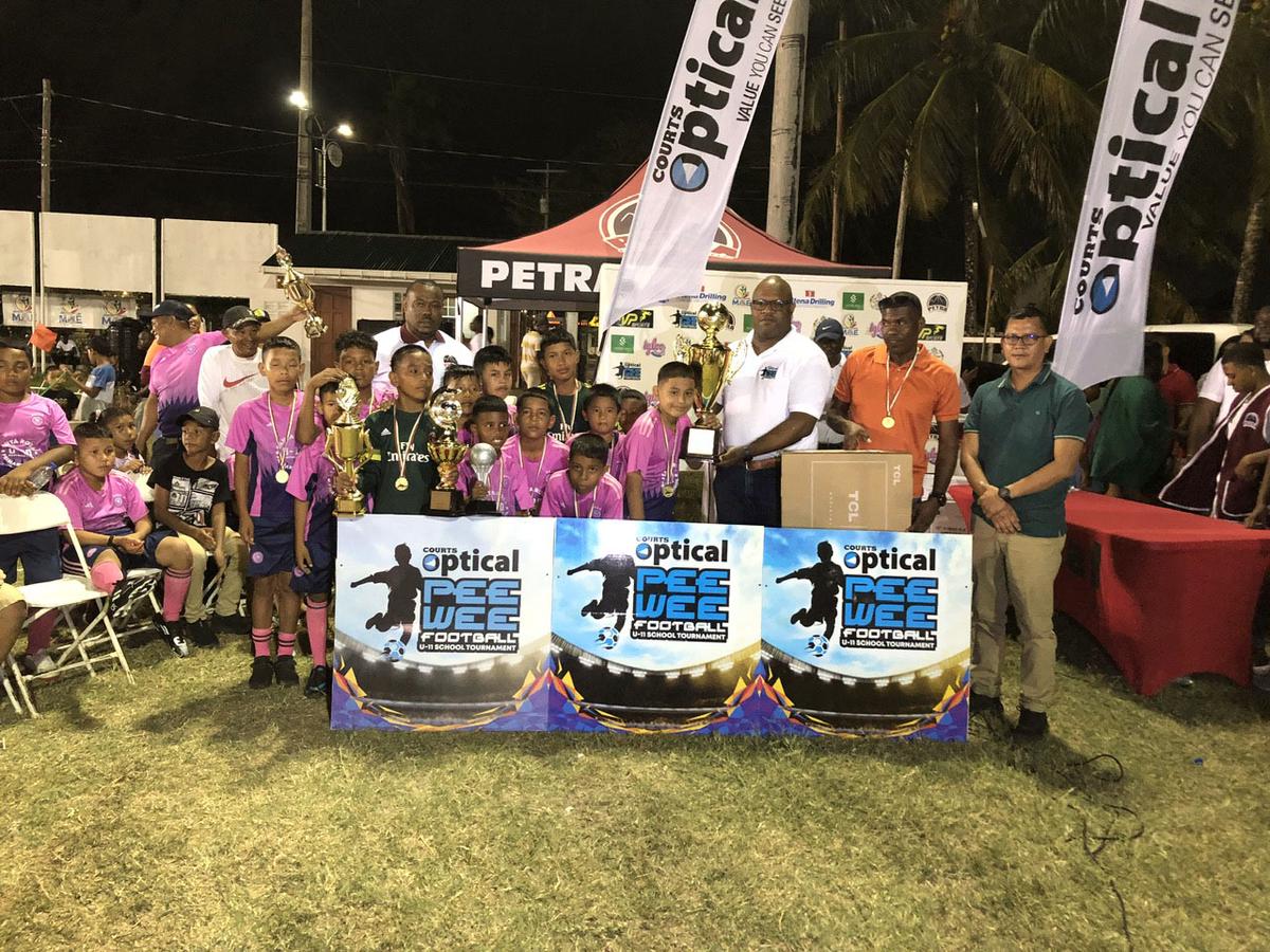 The victorious Santa Rosa unit receives the championship trophy after defeating Marian Academy in the final of the Courts Pee Wee U-11 Football Championship.