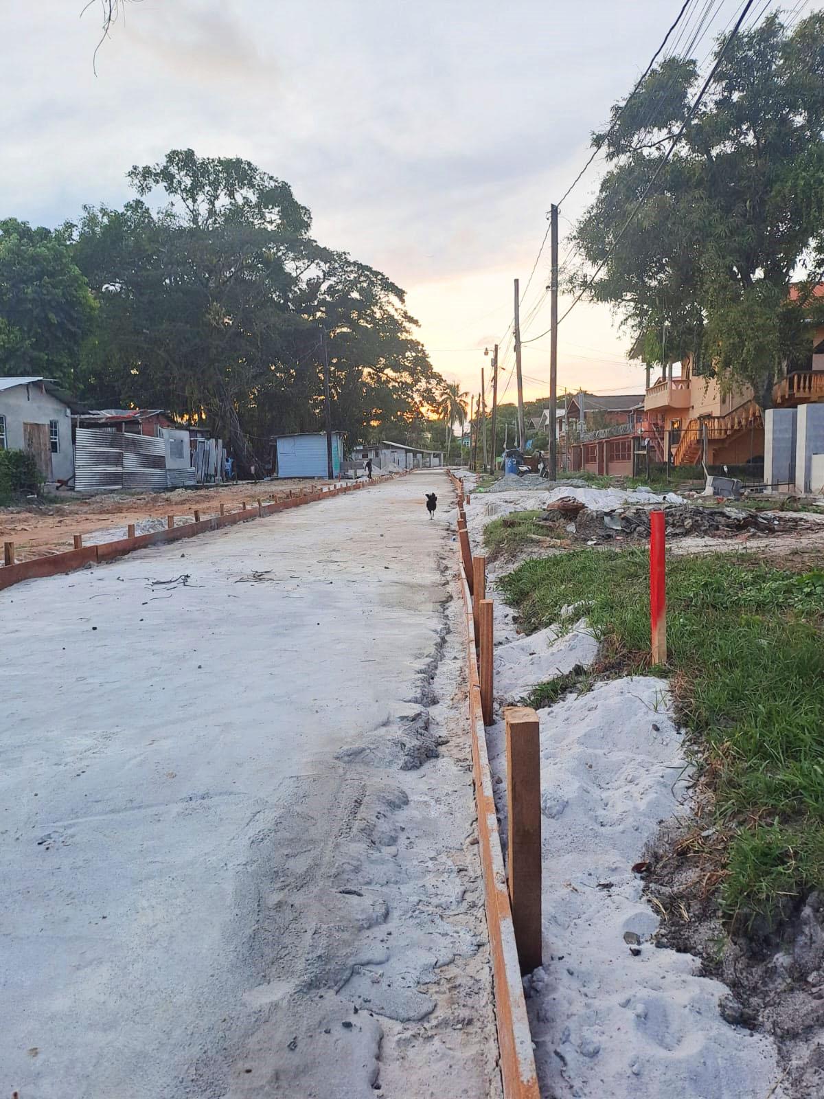 The ongoing roadworks in Tucville, the red stick to the right depicts the measured and outlined part of the road that was done by engineers