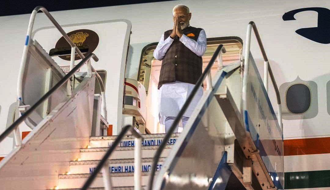 Indian Prime Minister Narendra Modi offering the traditional greeting of namaste when he appeared at the top of the stairs on which he descended from his aircraft last night at the CJIA. (Screenshot from NCN’s feed)