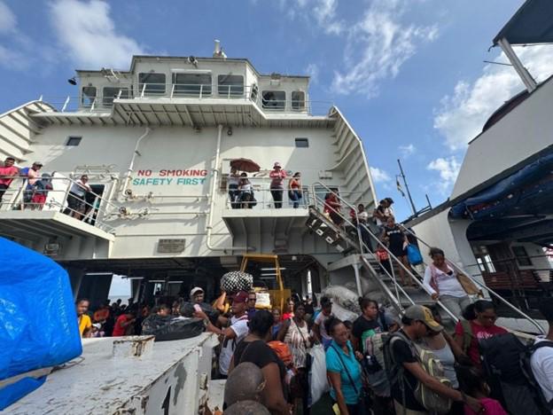 Passengers disembarking the MV MA Lisha (DPI photo)