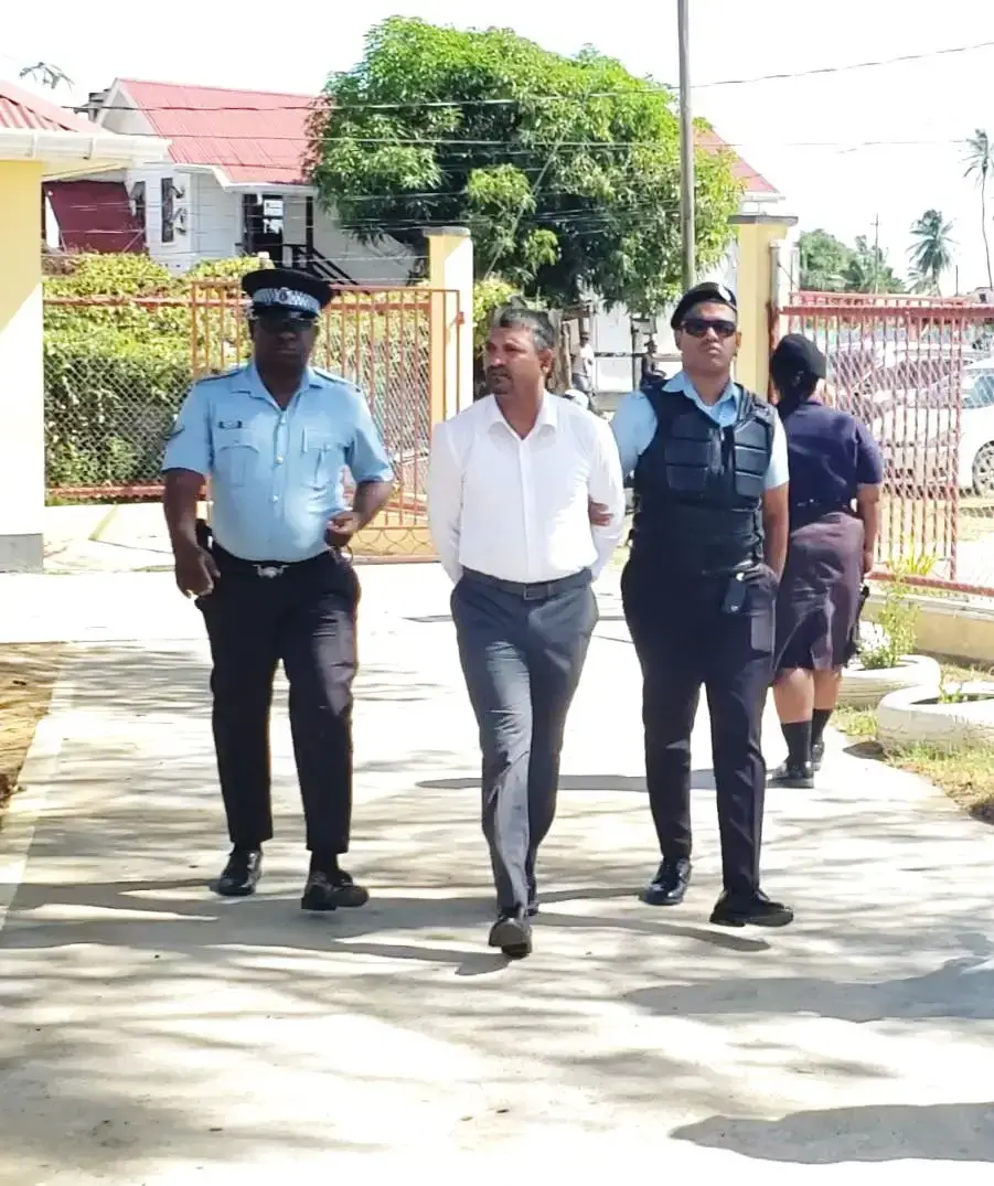 Poultry vendor Seeindra Marimutoo (centre) leaving the Whim Magistrate’s Court after the indictable charge was read to him.