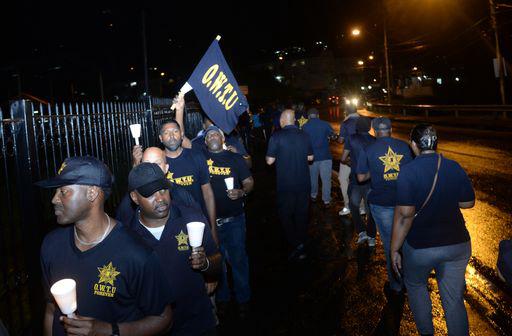 OWTU members outside the Prime Minister's residence in St Ann's, last evening.