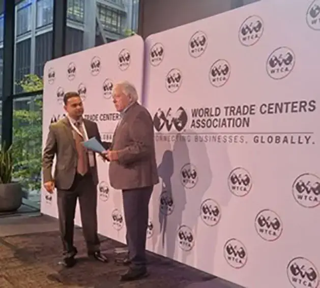 World Trade Center Georgetown Finance Director, Vasudeo Singh (left) presents a summary of the copyright study to World Trade Centers Association Chairman John Drew at the forum in New York