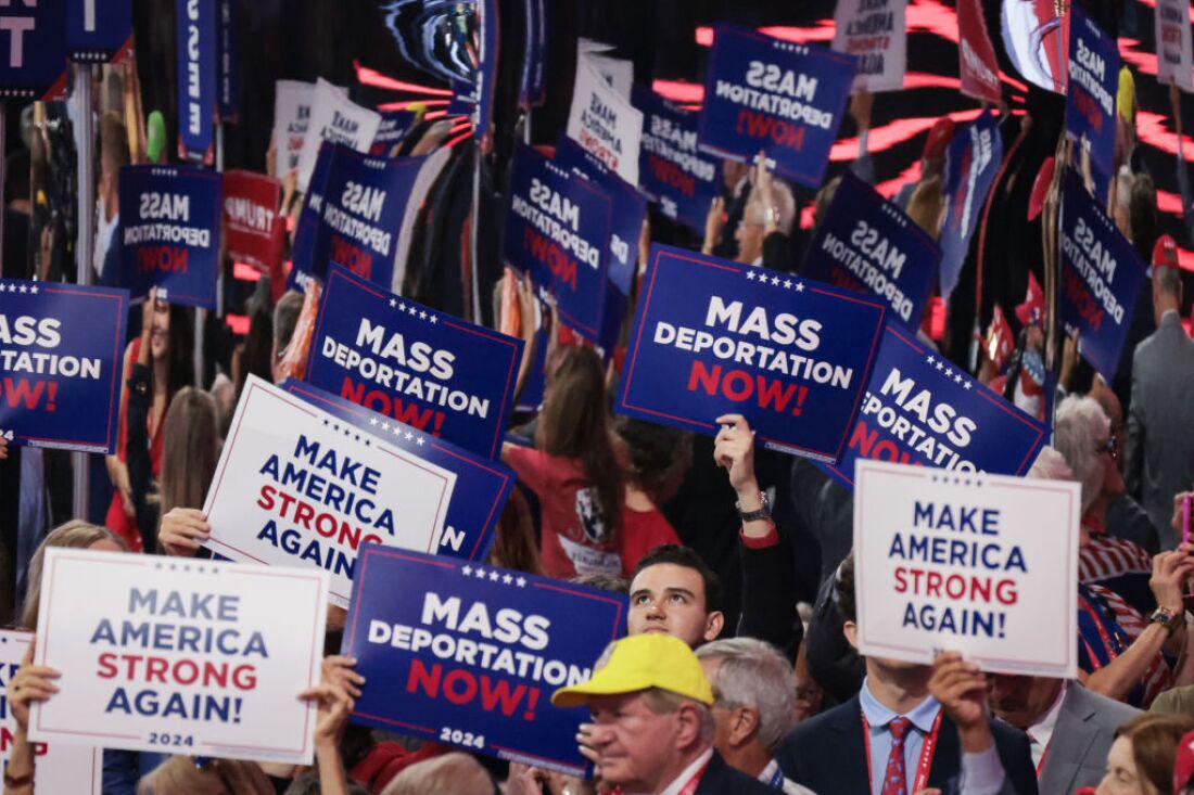 MILWAUKEE, WISCONSIN - JULY 17:  People hold signs that read "Mass Deportation Now" and "Make America Strong Again" on the third day of the Republican National Convention at the Fiserv Forum on July 17, 2024 in Milwaukee, Wisconsin. Delegates, politicians, and the Republican faithful are in Milwaukee for the annual convention, concluding with former President Donald Trump accepting his party's presidential nomination. The RNC takes place from July 15-18.  (Photo by Scott Olson/Getty Images)