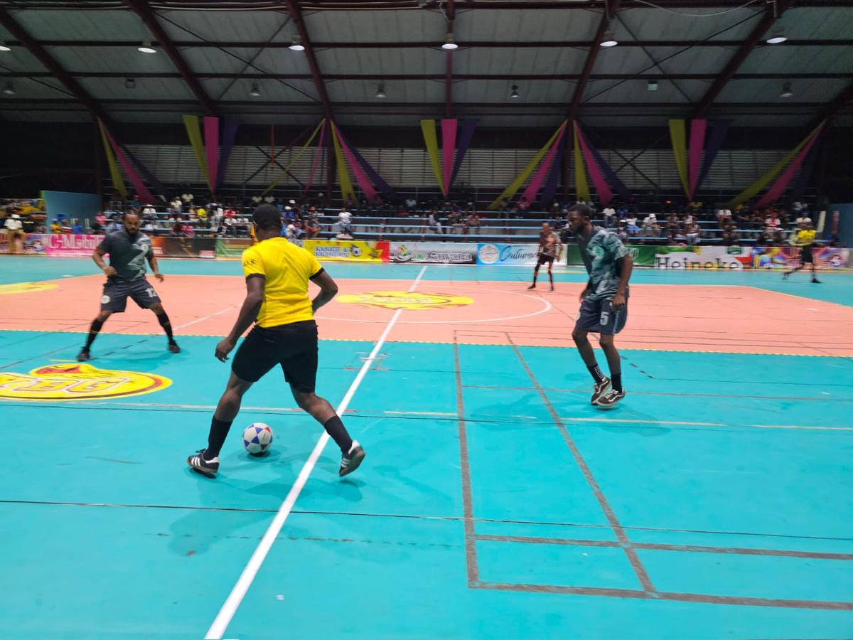 Action in the Kashif and Shanghai National Futsal Championship between Showstoppers (gray)and Stabroek Ballers B