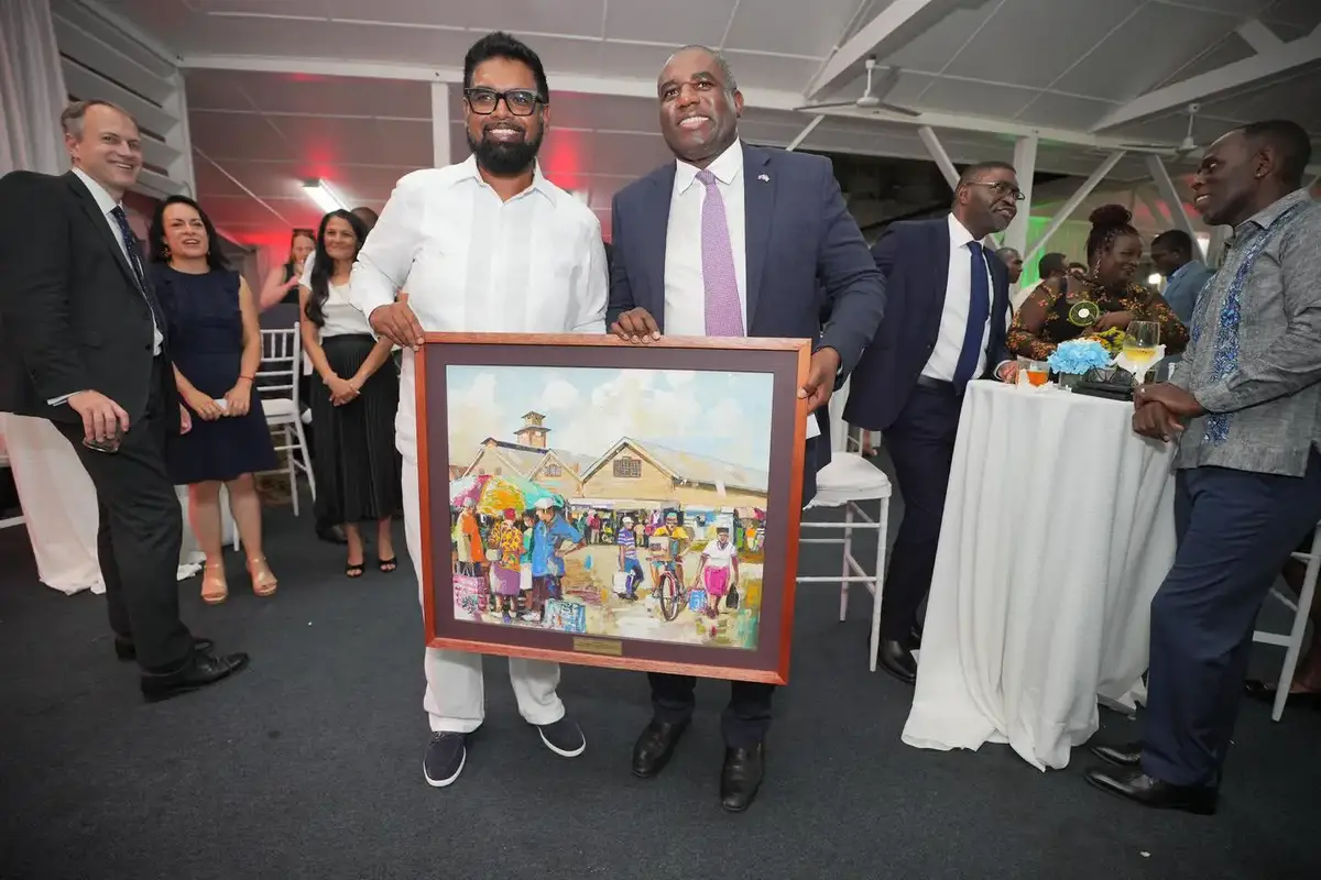 President Irfaan Ali (left) and UK Foreign Secretary David Lammy with a painting of local scenery (Office of the President photo)