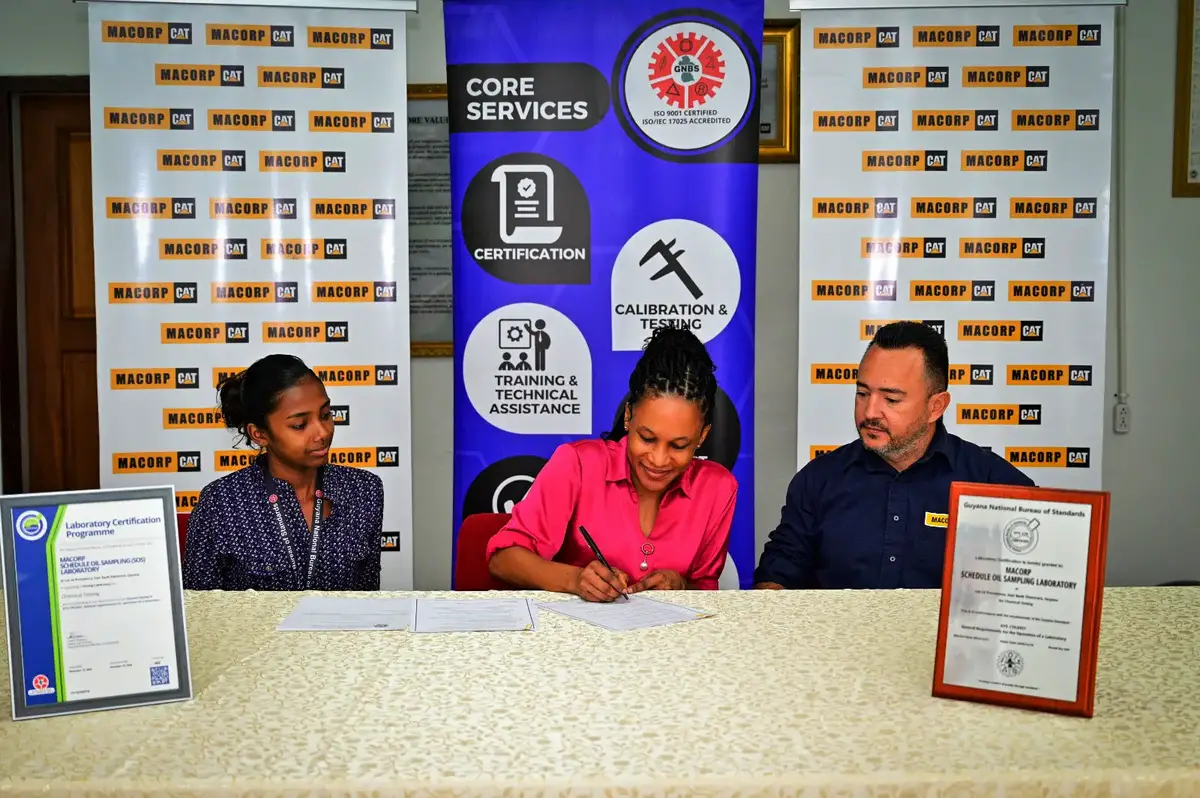 MACORP Quality Coordinator, Karen Clarke (centre) signing the agreement (MACORP photo)